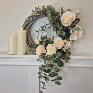 Cream rose and eucalyptus wreath on natural wicker base – exclusive to Lily Bloom. Buy online at www.lilybloom.ie or visit our Gorey store.