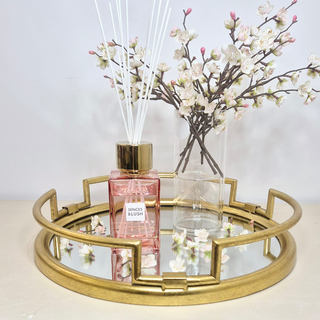 A beautifully styled Blush Harmony Bundle, featuring a Pink SENSES Blush Diffuser, delicate Cherry Blossom sprays in a glass cylinder vase, all elegantly arranged on a gold mirror tray—the perfect addition to any space.