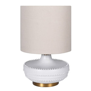 White ceramic table lamp with raised bobble detail, natural linen shade, and brushed brass base available from Lily Bloom, Gorey Y25TF63 or www.lilybloom.ie