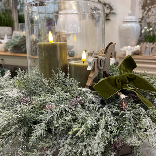 Close-up of Collette’s winter centre piece featuring greenery wrap, LED candle and signature velvet bow. Buy online at www.lilybloom.ie
