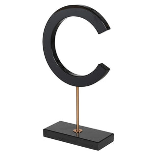 Glossy black marble letter C sculpture on gold metal stand styled on a console table, Lily Bloom Gorey Ireland