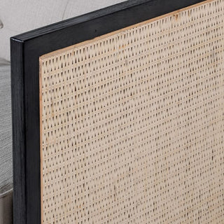 Close-up of the Eric Rattan-Sided Sofa by Lily Bloom — detailed view of woven rattan side panels with contrasting black trim and smooth oak frame, showcasing refined natural craftsmanshi