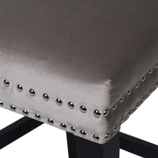 Close-up of Matteo Barstool fabric and studwork — soft taupe velvet with antique iron studs and smooth black leg finish.
