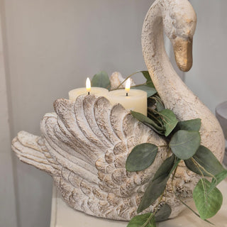 Regal swan ornament styled with LED candles and faux eucalyptus on a console table decorative display available exclusively from Lily Bloom Interiors Wexford