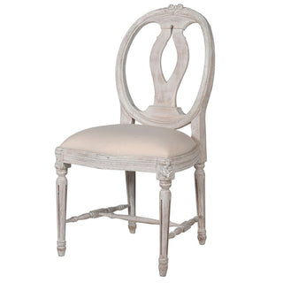 The Marcel Chair – French-inspired carved wood dining chair with linen-blend upholstery. Delivery included across Ireland. Available at Lily Bloom, Gorey.