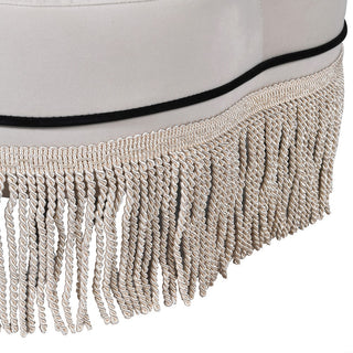 Close-up of the sculpted silhouette and piped trim on the Toulon Ottoman